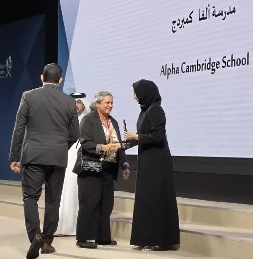 The Clear Flag trophy being presented to Alpha Cambridge School on stage